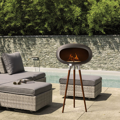 Tripod Ethanol Fireplace adding a warm, smokeless glow to an outdoor patio gathering next to a pool.