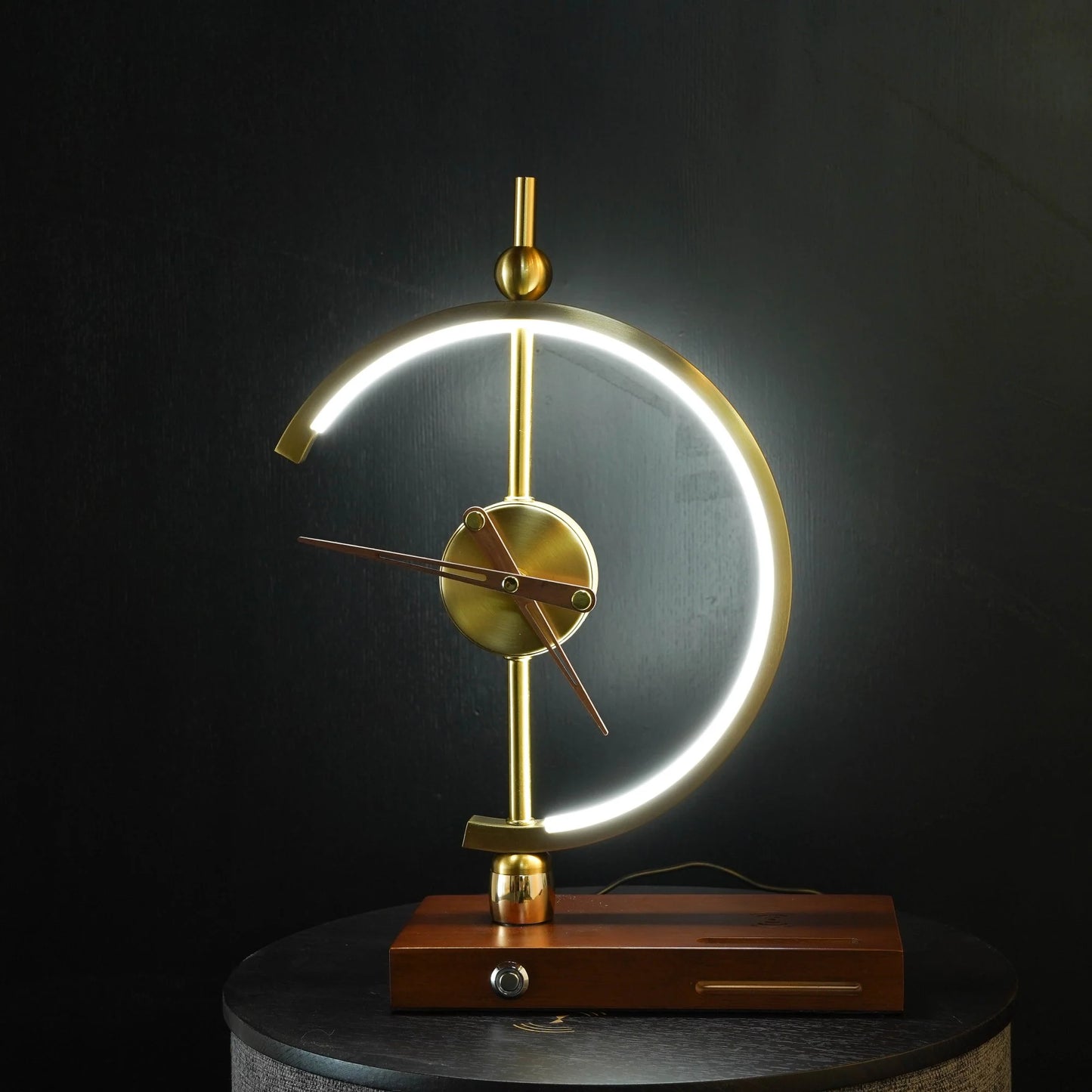 GoldenArc Desk Clock & Lamp – at night, bright setting, on end table.