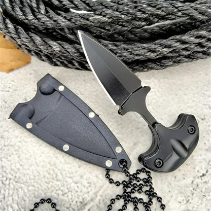 Black pocket knife with sheath and chain on a textured surface